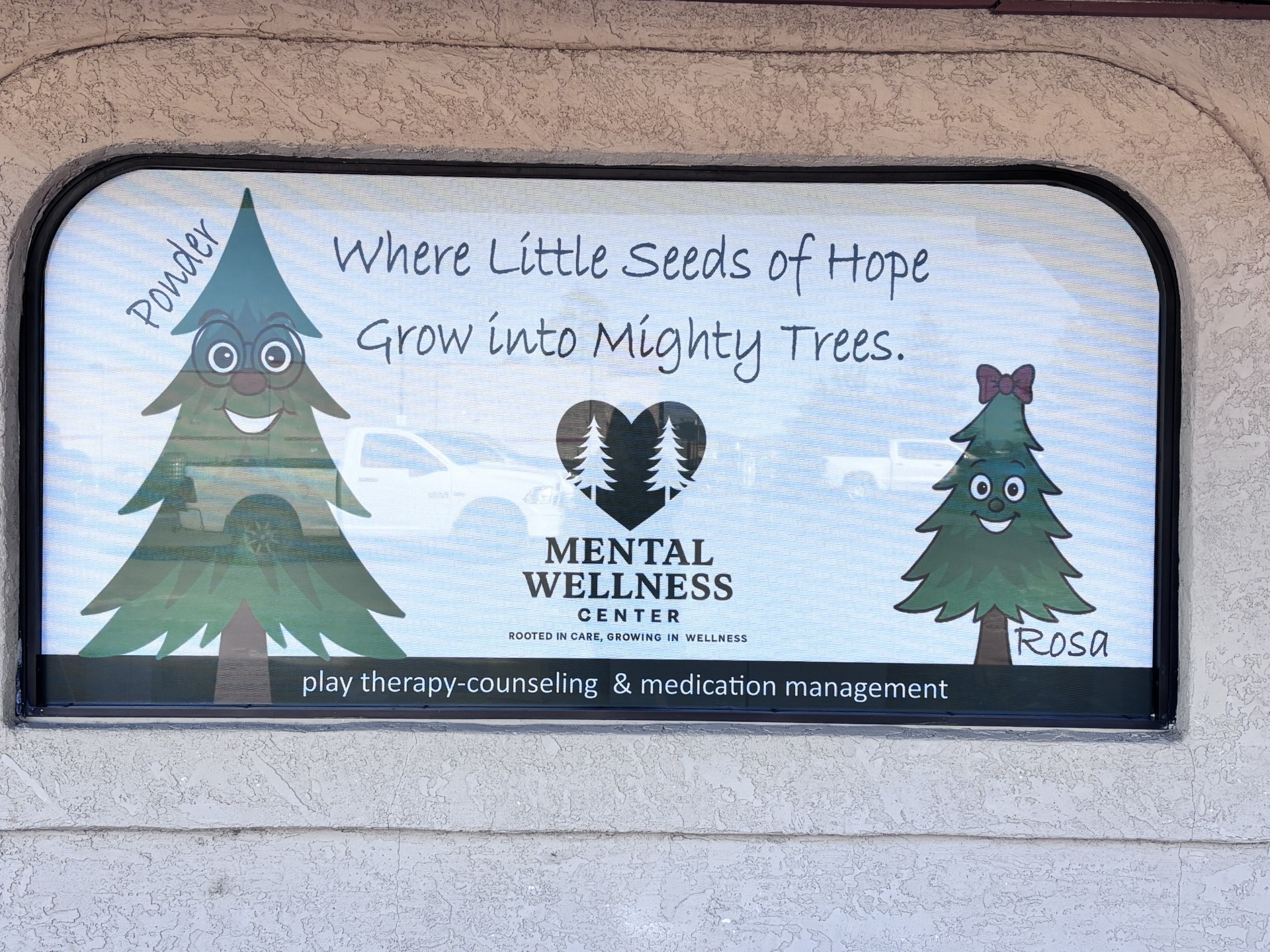 Office window sign with Ponder and Rosa tree characters and the words play therapy, counseling and medication management.